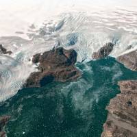 This file photo taken in September and provided by NASA Earth Observatory shows glaciers observed from the HU-25A Guardian aircraft on Sept 2, showing the Brückner and Heim glaciers where they flow into Johan Petersen Fjord in southeastern Greenland. Oceans rose 50 percent faster in 2014 than 1993, with the Greenland Ice Sheet’s share of total sea level rise jumping from 5 to 25 percent over the same period, researchers reported on Monday. Melting Greenland ice now source of 25% of sea level rise, researchers say