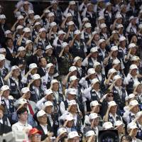 Korean War veterans salute during a ceremony marking the 67th anniversary of the Korean War in Seoul on Sunday. | AP