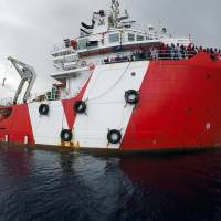 Migrants are seen aboard the Vos Hestia after being rescued by Save the Children NGO crew in the Mediterranean off Libya Sunday. | REUTERS
