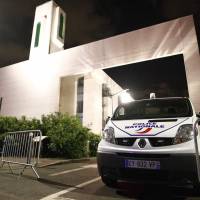 A police vehicle is stationed outside a mosque Thursday in the Paris suburb of Creteil after a man tried to drive a car into a crowd front of the Islamic religious facility. | AFP-JIJI