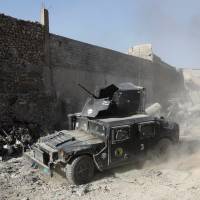 Armored fighting vehicles of the Counter-Terrorism Service maneuver at the positions of the Iraqi forces near the Grand al-Nuri Mosque at the Old City in Mosul, Iraq, Thursday. Iraqi leader declares end to Islamic State caliphate as forces retake Mosul mosque ruins