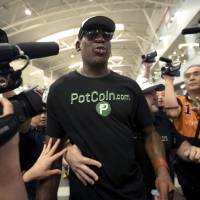 Former NBA basketball player Dennis Rodman arrives at Beijing International Airport Tuesday, ahead of a planned visit to North Korea. | AP