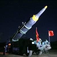 North Korean leader Kim Jong Un inspects the intermediate-range Hwasong-12 ballistic missile in this photo released May 15. | REUTERS