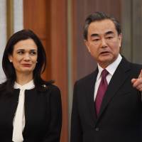 Panama Vice President and Foreign Minister Isabel de Saint Malo and Chinese Foreign Minister Wang Yi chat during a ceremony on establishing diplomatic relations in Beijing on Tuesday. Panama establishes ties with China, ditches Taiwan in win for Beijing