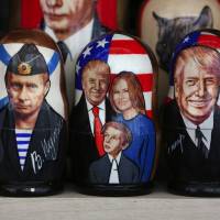 Souvenir matryoshka dolls depicting Russian President Vladimir Putin, as well as U.S. leader Donald Trump and his family, are displayed at a tourist stall in St. Petersburg, Russia, on May 31. | BLOOMBERG