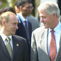 President Bill Clinton (right) shares a light moment with Russian President Vladimir Putin before a Group of Eight meeting in Nago, Okinawa, in 2000. In a series of interviews with American film director Oliver Stone being shown on U.S. television on Monday, Putin said that he inquired about Russia joining NATO when Clinton visited Moscow in 2000. Oscar-winner Stone brings Putin interviews to U.S. prime time TV
