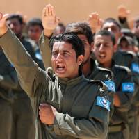 Graduates of a U.S.-trained police force expected to be deployed in Raqqa, Syria, salute during a graduation ceremony near Ain Issa village, north of Raqqa, the de facto IS capital, on Saturday. Without comprehensive U.S. strategy in Syria, Trump risks wider war