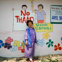 Do Geum-ryeon poses for photographs during an anti-THAAD protest, in Seongju, South Korea, on Wednesday. Their lives disrupted, South Korean grannies vow to fight U.S. THAAD deployment to the end