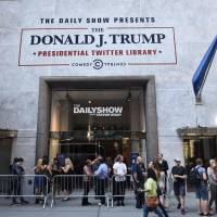 Members of the media line up for a press preview of the Trump Presidential Twitter Library, created by \"The Daily Show with Trevor Noah,\" on Thursday in New York. | AFP-JIJI