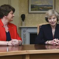 Democratic Unionist Party leader Arlene Foster meets with British Prime Minister Theresa May in Belfast last July. | AP