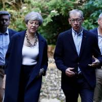 British Prime Minister Theresa May and her husband, Phillip, arrive at church in Sonning, England, on Sunday. How May's sure thing became political disaster for the ages