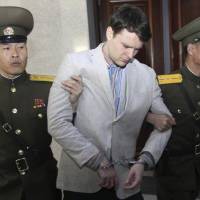 U.S. college student Otto Warmbier is seen being escorted at North Korea\'s Supreme Court in Pyongyang in March 2016. Warmbier\'s family announced his death Monday, just days after he was freed by the regime of Kim Jong Un. | AP