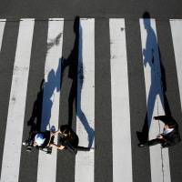 A mother and her child in Tokyo on Friday. Population takes record dip as births fall below 1 million for first time since 1899
