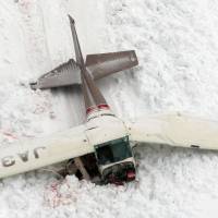 The wreckage of a Cessna 172P that crashed during a training flight Saturday in Toyama Prefecture is shown early Sunday. All four aboard were killed. | KYODO