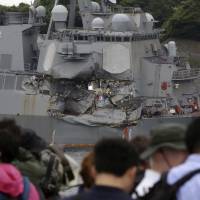 Journalists examine the damaged USS Fitzgerald at Yokosuka naval base in Kanagawa Prefecture on June 18. | AP