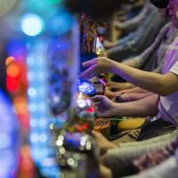 Customers at a pachinko parlor in Tokyo on May 16. | BLOOMBERG