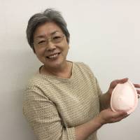 Mieko Ichinomiya displays a hand-sewn pad for breast cancer survivors on Thursday in Sapporo. She developed the pad as she was recovering from cancer herself. Hokkaido cancer survivor's hand-sewn breast pads offer a softer path to recovery