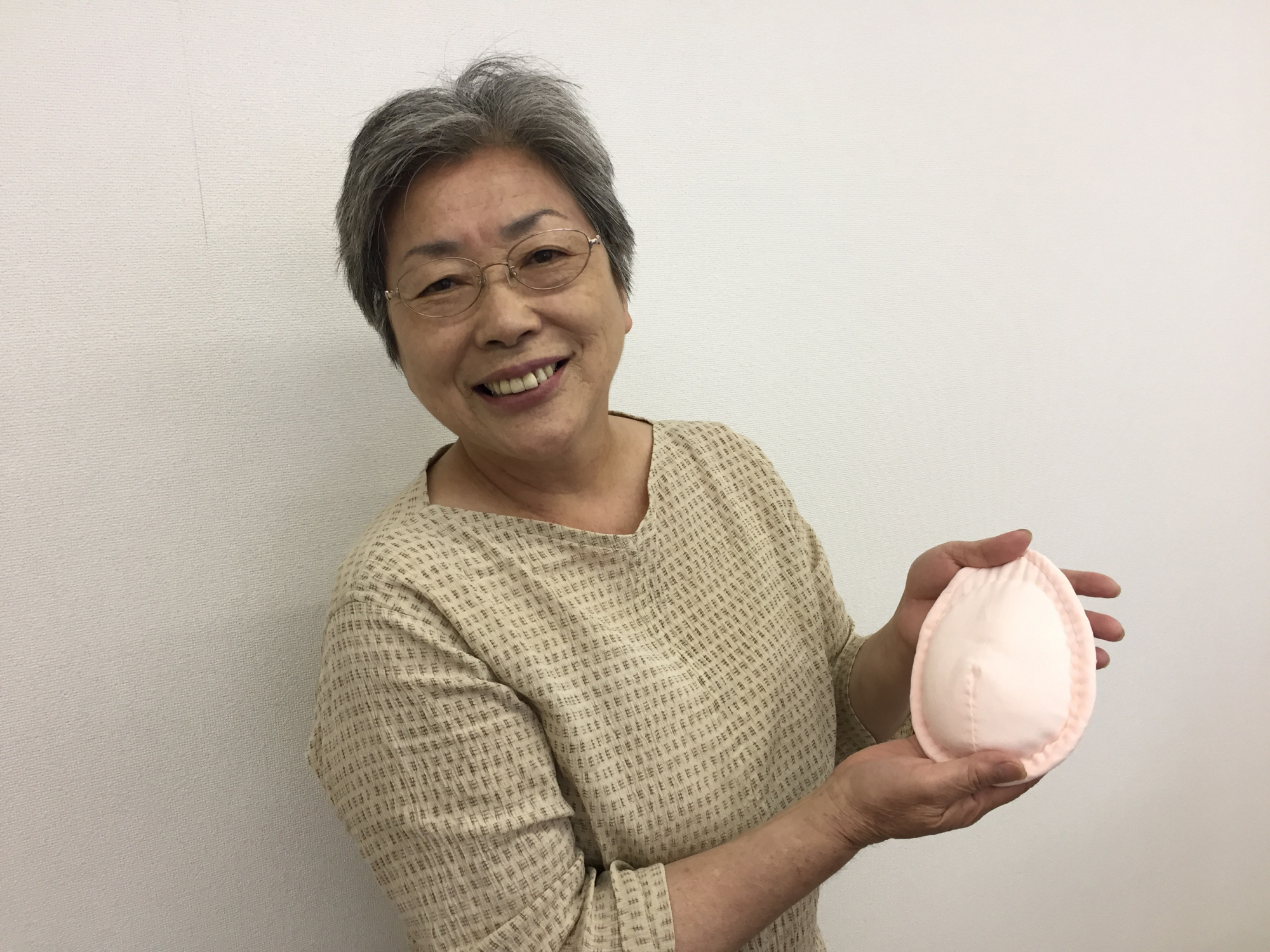 Mieko Ichinomiya displays a hand-sewn pad for breast cancer survivors on Thursday in Sapporo. She developed the pad as she was recovering from cancer herself. | SUMIKO OSHIMA