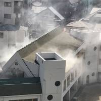 Smoke rises from Ikusei Kindergarten in Osaka\'s Miyakojima Ward May 30 in a photo provided by a witness. | KYODO