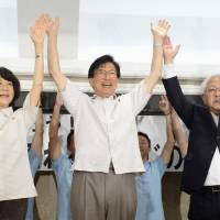 Shizuoka Gov. Heita Kawakatsu raises his hands in celebration in the city of Shizuoka during Sunday\'s gubernatorial election. His victory over Olympic judoka Noriko Mizoguchi was confirmed later in the day, giving him a third four-year term. | KYODO