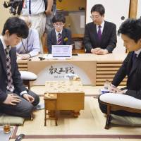 Professional shogi player Sota Fujii, 14, faces off against Ryuma Tonari (right) at Tokyo\'s Shogi Kaikan Hall on Saturday. | KYODO