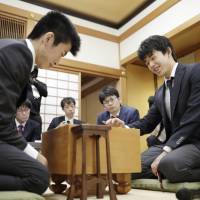 Sota Fujii (right), the nation\'s youngest professional shogi player at 14, cruises to his 27th consecutive victory Saturday in the city of Osaka. If he prevails again, he will match the record for longest winning streak in the Japanese board game. | KYODO