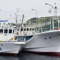 A coast guard patrol boat docks next to another boat Thursday at the Nagoya port in Karatsu, Saga Prefecture. A record 206 kg of smuggled gold was found from the boat. | KYODO
