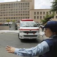 An ambulance leaves the Sendai District Court Friday after two police officers were stabbed by a defendant. | KYODO