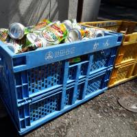 Cans and bottles are separated into specific recycling crates and left by the side of the road for collection in Tokyo\'s Setagaya Ward. | TIM HORNYAK