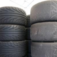 Tired out: Burnt out slick tires (right) stand next to unused treaded tires in a paddock at Autopolis in Oita Prefecture. | OSCAR BOYD
