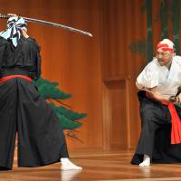Sharp end: Tetsuro Shimaguchi (right) demonstrates his swordfighting technique at the Kanze Noh Theater in Tokyo’s Ginza district on May 30. Ginza's new noh theater seeks to break down cultural barriers