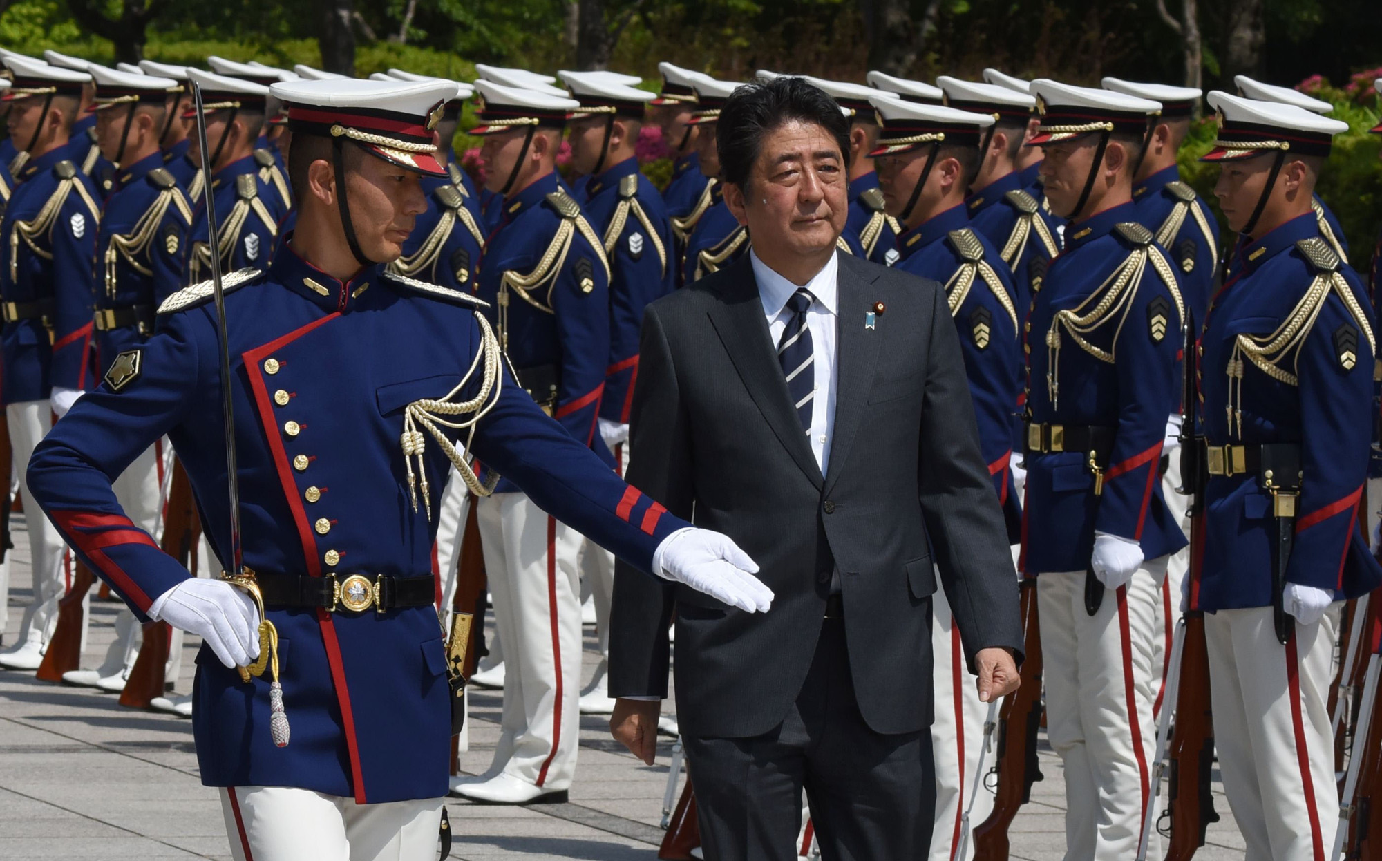 Prime Minister Shinzo Abe, shown reviewing an honor guard at a Tuesday ceremony to mark the return of SDF peacekeepers, is on an ideological mission to reshape the Japanese state. | AFP-JIJI