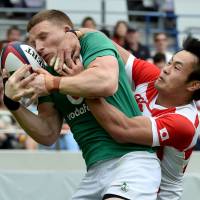 Japan\'s Kenki Fukuoka tackles Ireland\'s Andrew Conway during Saturday\'s test match in Tokyo. | AFP-JIJI