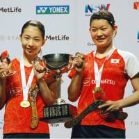 Ayaka Takahashi (right) and partner Misaki Matsutomo, seen after winning the Australian Open women\'s doubles title last weekend, will compete at the Japan Open in September. | KYODO