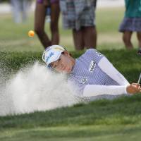 Chella Choi of South Korea hits out of a bunker on the 17th hole during the first day of the Women’s PGA Championship on Thursday in Olympia Fields, Illinois. Choi, Yang shoot 5-under 66, tied for lead at Women's PGA Championship