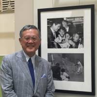 Masanori Murakami poses in front of photos of himself at the Pacific Pitch: U.S.-Japan Baseball Diplomacy exhibition Thursday at Tokyo Metropolitan Central Library on Thursday. Exhibition highlights legacy of U.S.-Japan baseball ties