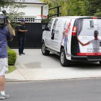 A television cameraman shoots video across from the front gate of a home belonging to Cleveland Cavaliers\' LeBron James Wednesday in Los Angeles. Police are investigating after someone spray-painted a racial slur on the front gate of James\' home in Los Angeles on the eve of the NBA Finals. | AP