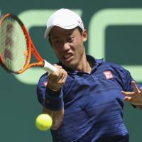Kei Nishikori  returns a shot to Fernando Verdasco  at the Gerry Weber Open on Tuesday. | AP