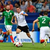 Germany’s Julian Draxler (center) takes on two Mexico defenders during their Confederations Cup semifinal on Thursday in Sochi, Russia. Germany whips Mexico in semis