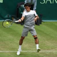 Yuichi Sugita plays a shot during his match against Roger Federer at the Gerry Weber Open in Halle, Germany, on Tuesday. Sugita falls to Federer in Gerry Weber Open
