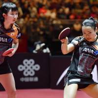 Mima Ito plays a shot as doubles partner Hina Hayata watches on during their Table Tennis World Championships semifinal against China\'s Ding Ning and Liu Shiwen on Monday. | KYODO