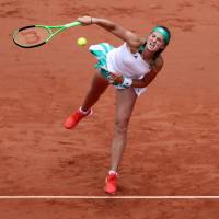 Latvia’s Jelena Ostapenko serves during her quarterfinal match against Caroline Wozniacki at the French Open on Tuesday. Ostapenko won 4-6, 6-2, 6-2. Unseeded teen Ostapenko makes semifinals
