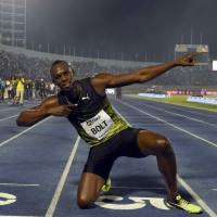 Usain Bolt strikes his trademark victory pose after winning the 100-meter race at the Racers Grand Prix in Kingston on Saturday. Nervous Bolt wins final 100 meters on home soil