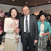 Bulgarian Rose Cultural Association President Fumie Yamashita (left) greets Bulgarian Ambassador Borislav Kostov (center) and his wife, Manya (right), during the Third Rose Day Charity Party at the ambassador\'s residence in Tokyo on June 2. | YOSHIAKI MIURA