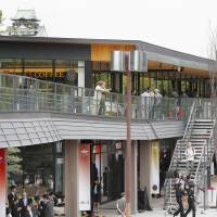 People check out the new Jo-Terrace Osaka commercial complex in Osaka Castle Park on Thursday. The two-story complex houses stores, cafes, eateries and a tourism office that offers multilingual information to tourists of all kinds. | KYODO