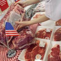 An employee arranges U.S. beef products at a Tokyo supermarket. Japan decided Friday to raise tariffs on U.S. frozen beef imports from the current 38.5 percent to 50 percent from August until next March. Japan's emergency tariffs on frozen beef imports likely to irk U.S.