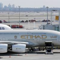 An Etihad plane sits at a gate at JFK International Airport in New York in March. | REUTERS