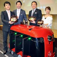 The CarriRo Delivery robot is unveiled in Tokyo on July 13. In field tests scheduled to be carried out in August, developer ZMP Inc. plans to deliver sushi with it. | KYODO