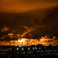 Flames and smoke rise Saturday above the Shell refinery in Rotterdam, Netherlands. Shell halts Europe's largest refinery after power station blaze