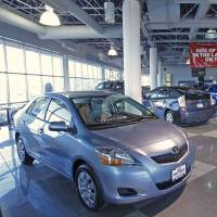 Toyota cars sit in a showroom in Orem, Utah. Toyota look to car rentals, fleet deliveries for boost amid slowing U.S. market